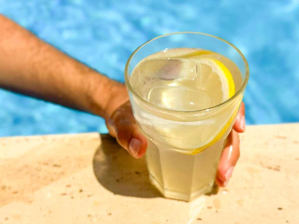 lemonade in hand next to the pool