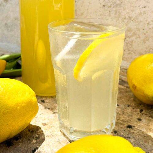 glass of limonata with fresh lemons