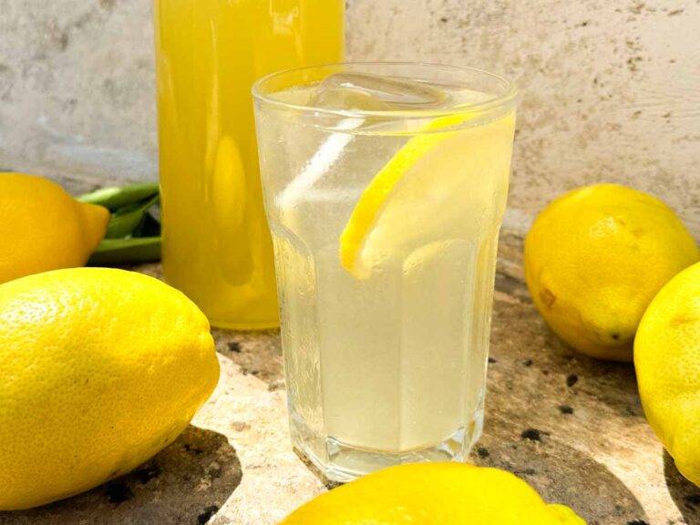 glass of limonata with fresh lemons