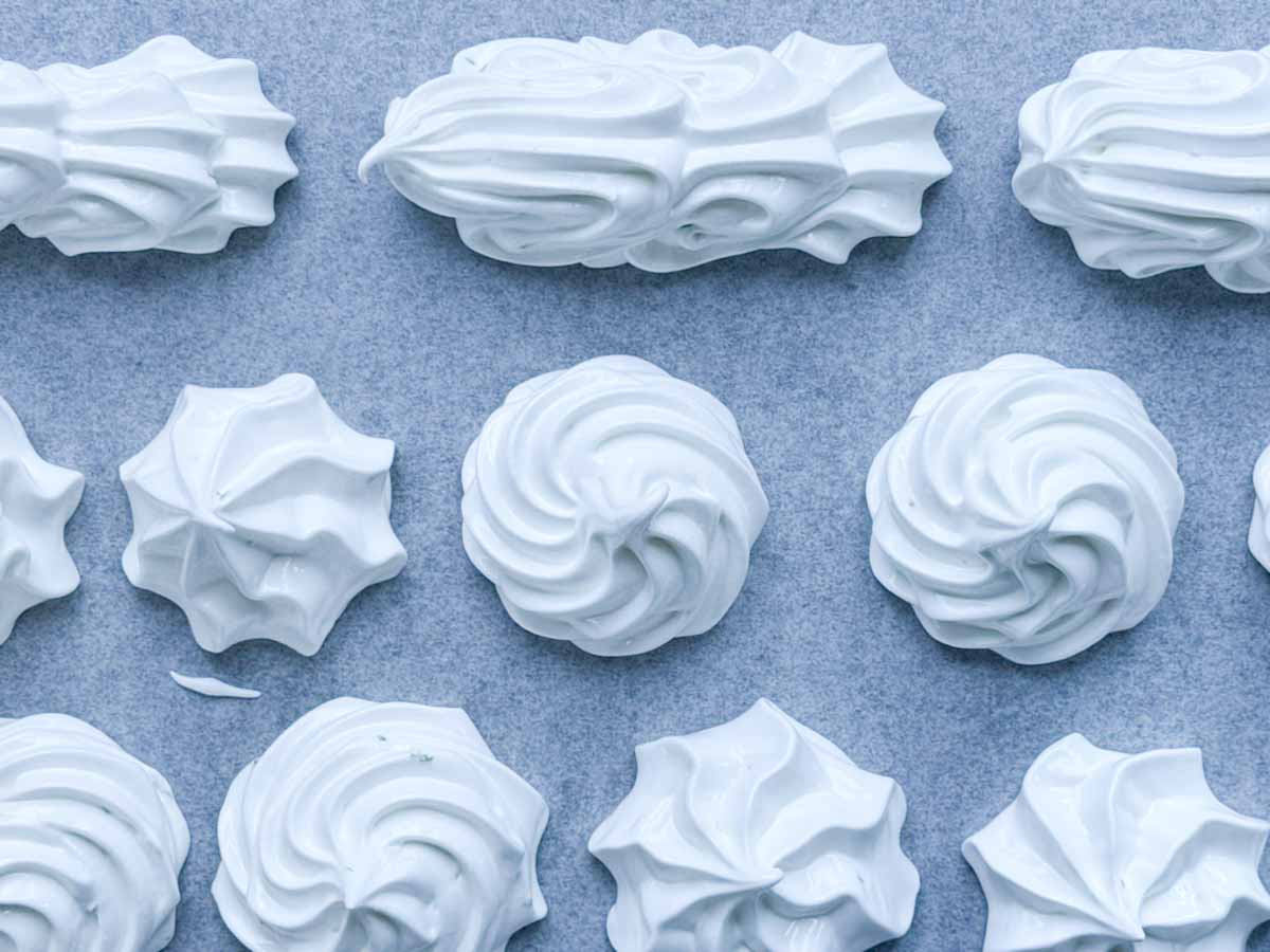 squeezed meringues on a baking sheet